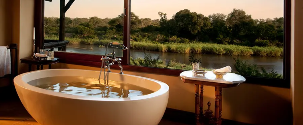 Bath at safari lodge looking out at river